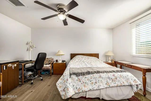 a bedroom with a bed a desk and chair