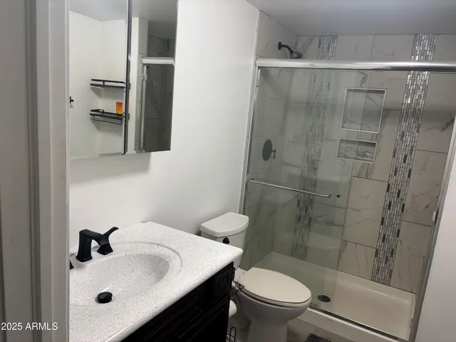 a bathroom with a sink toilet and shower