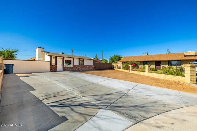 a front view of a building with a yard