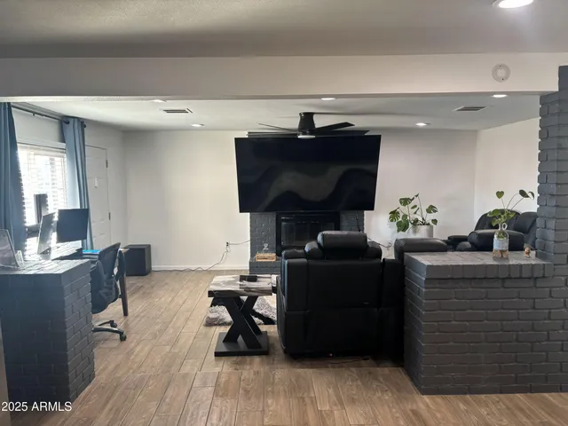 a living room with furniture and wooden floor