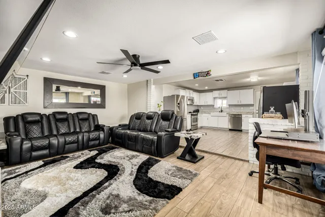 a living room with furniture window and a wooden floor