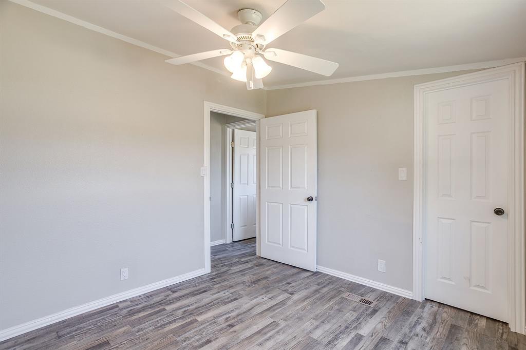 178 Valley Lake Lane Springtown, TX 76082 - Photo 24 of 33 Interior room featuring wood-finish flooring, light neutral wall paint, and white trim