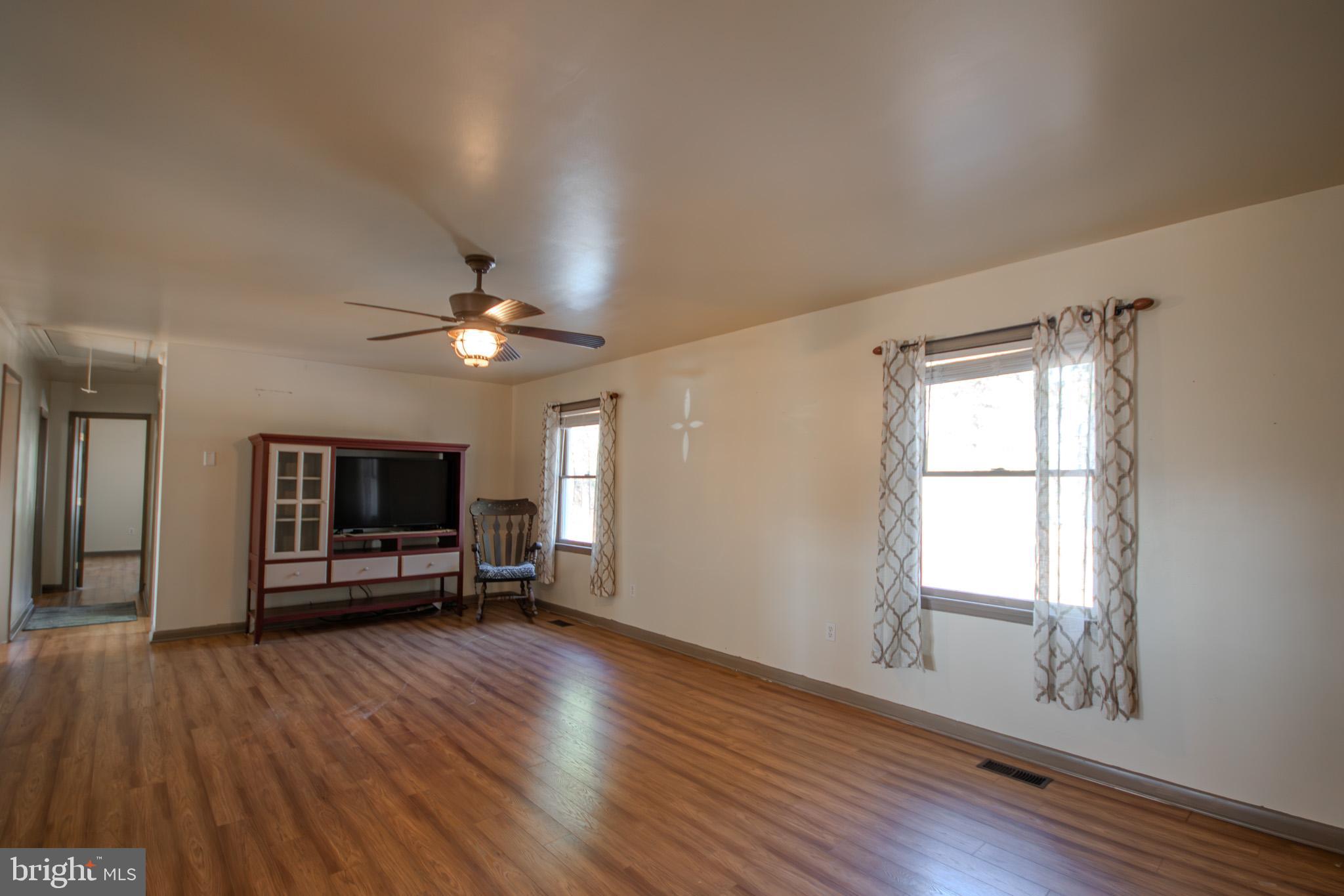 6761 Sharptown Road Laurel, DE 19956 - Photo 12 of 34 a view of a livingroom with furniture wooden floor and windows