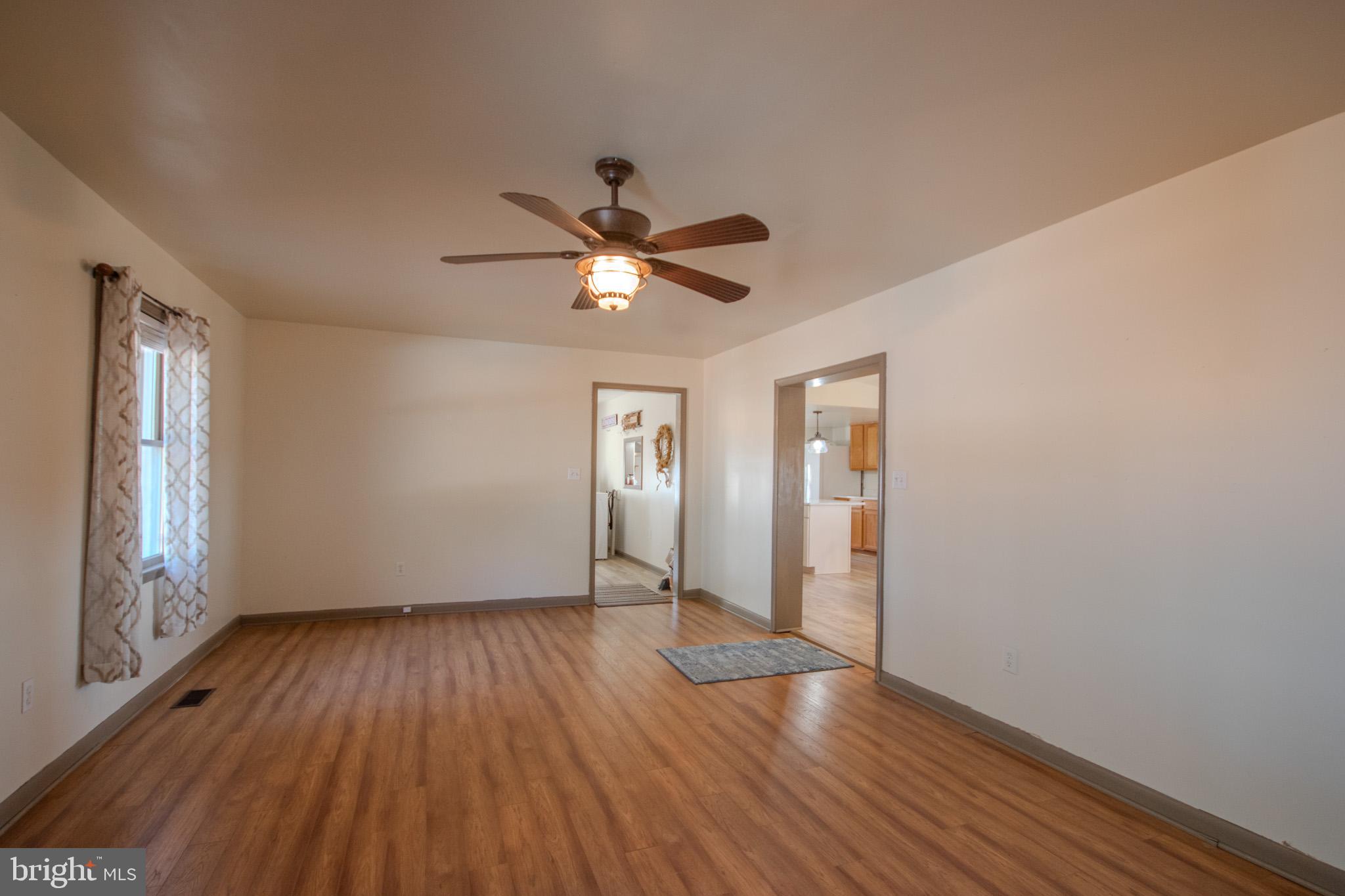 6761 Sharptown Road Laurel, DE 19956 - Photo 14 of 34 a view of an empty room with wooden floor and a window