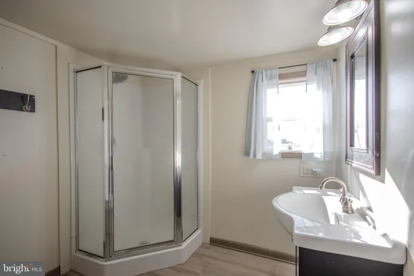 a bathroom with a sink a mirror and a window