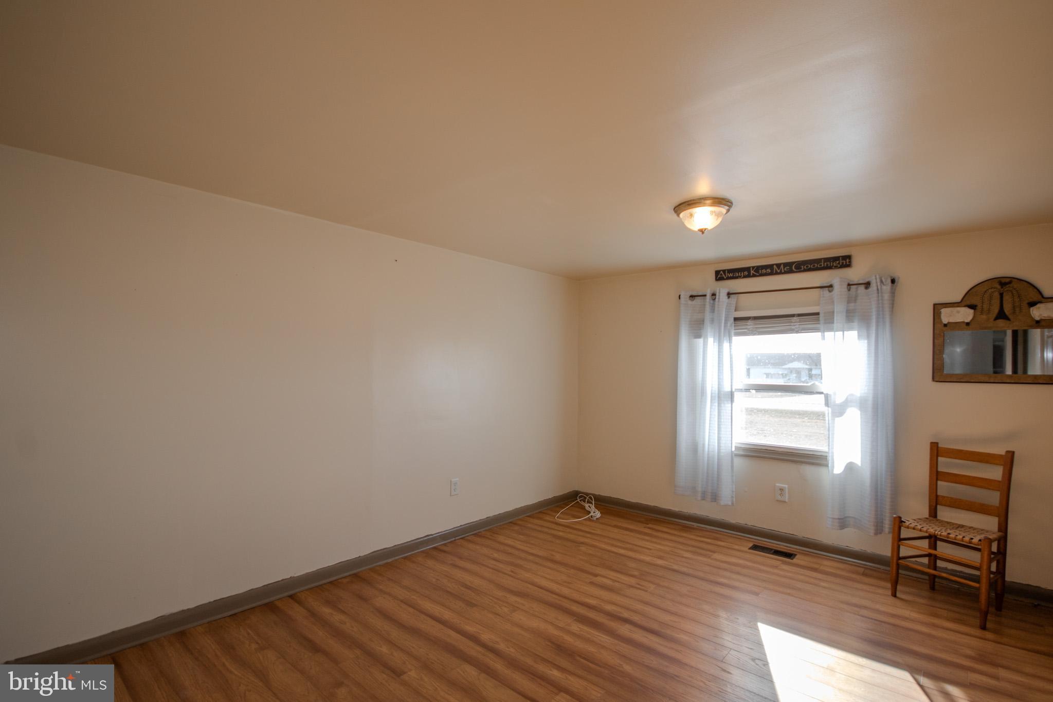 6761 Sharptown Road Laurel, DE 19956 - Photo 18 of 34 a view of empty room with wooden floor and fan