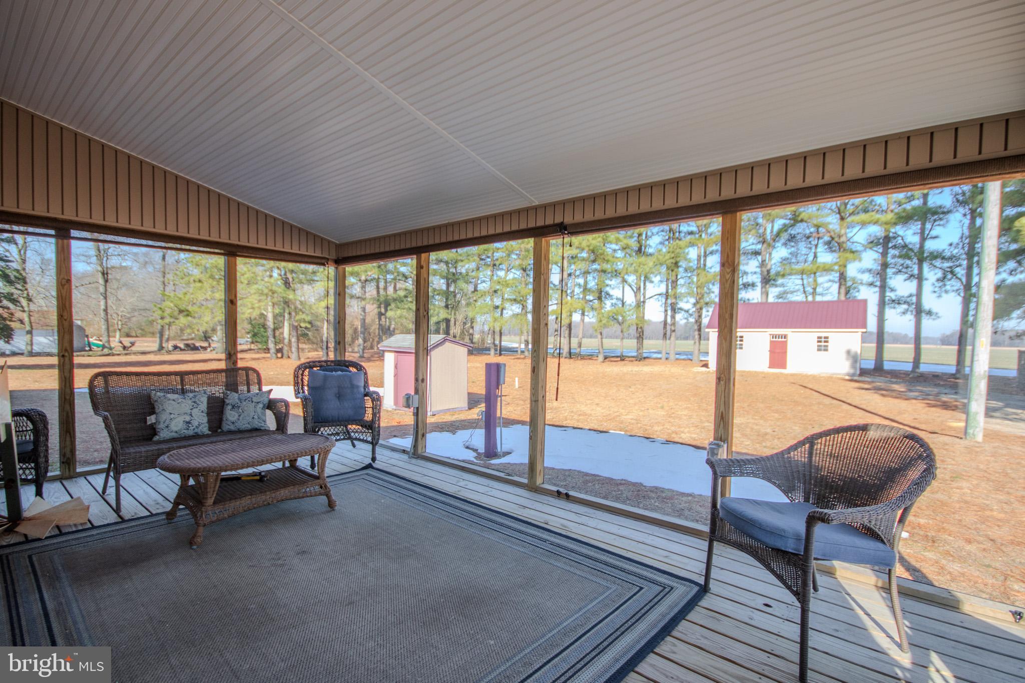 6761 Sharptown Road Laurel, DE 19956 - Photo 25 of 34 a living room with furniture and floor to ceiling windows