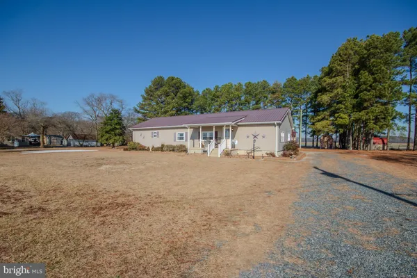 a view of house with outdoor space and tall tree