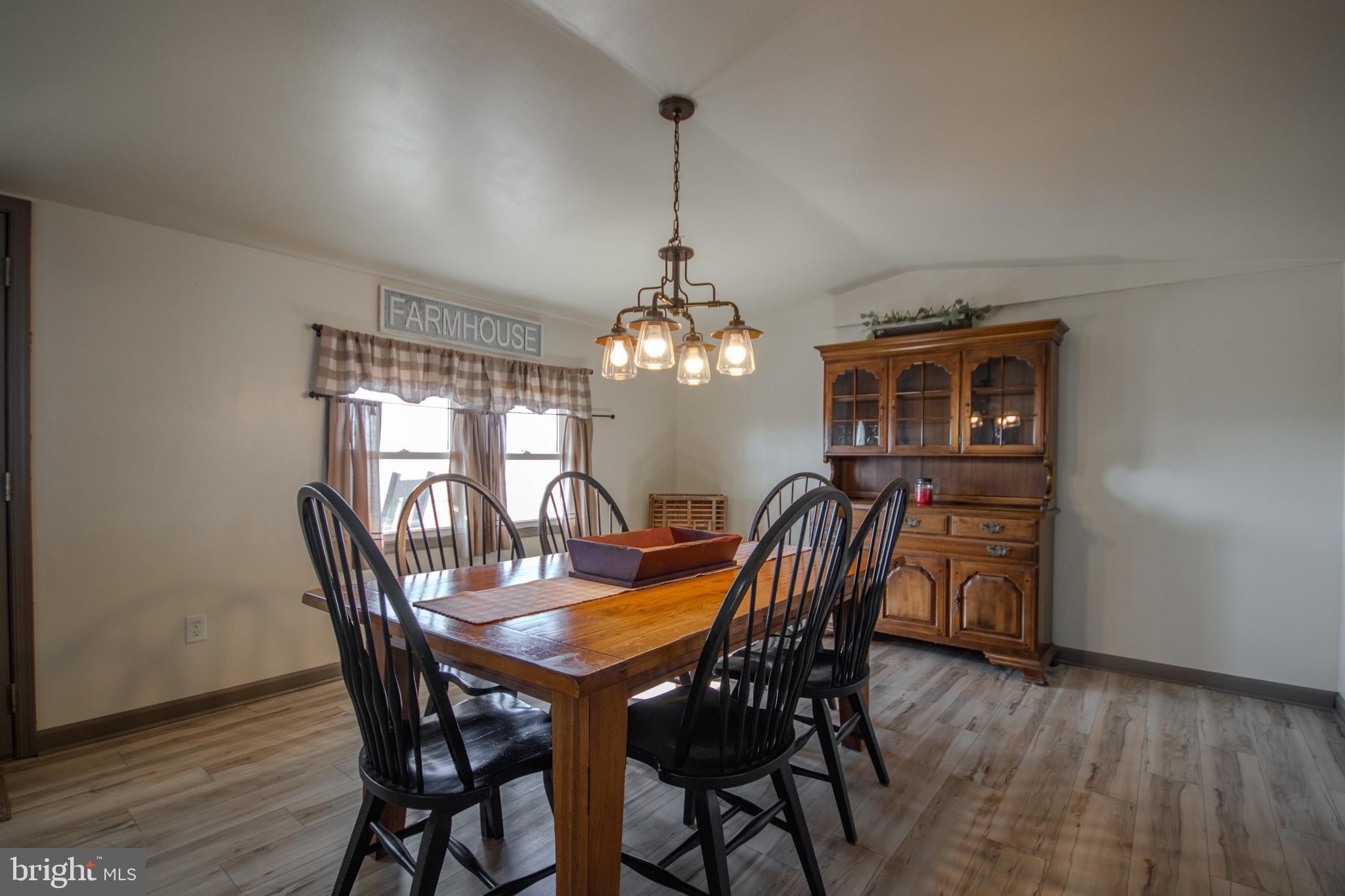 6761 Sharptown Road Laurel, DE 19956 - Photo 7 of 34 a view of a dining room with furniture window and wooden floor