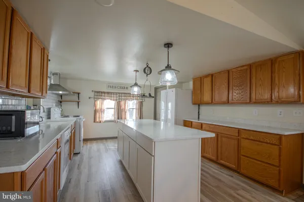 a kitchen with cabinets a sink and wooden floor