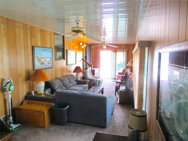 a living room with furniture a lamp and a large window