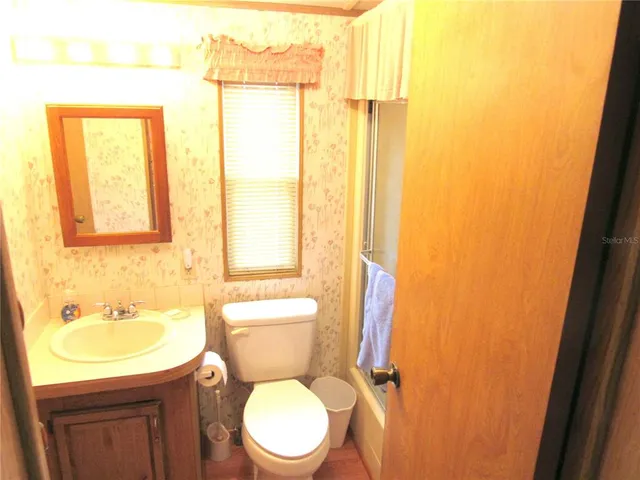 a white toilet sitting next to a bathroom sink
