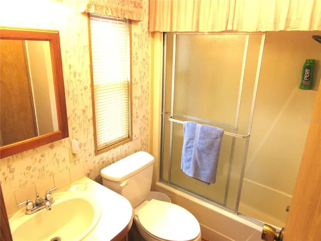 a bathroom with toilet sink and tub