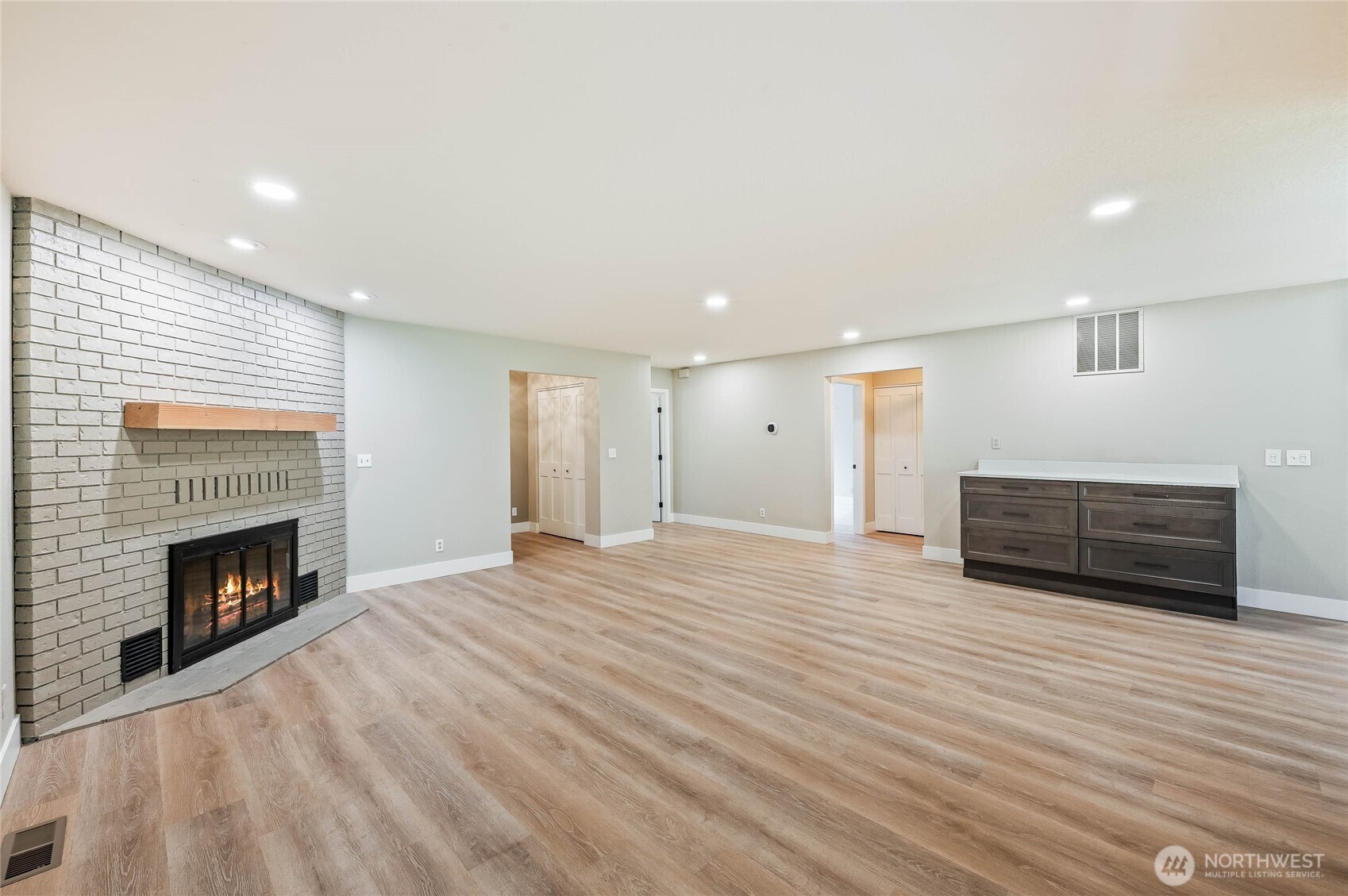 8975 Icicle Road, Unit F Leavenworth, WA 98826 - Photo 14 of 31 a view of empty room with wooden floor and fireplace