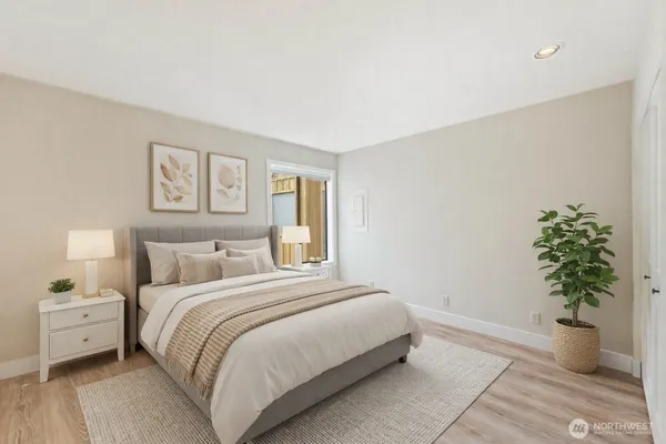 a bedroom with a bed and a potted plant