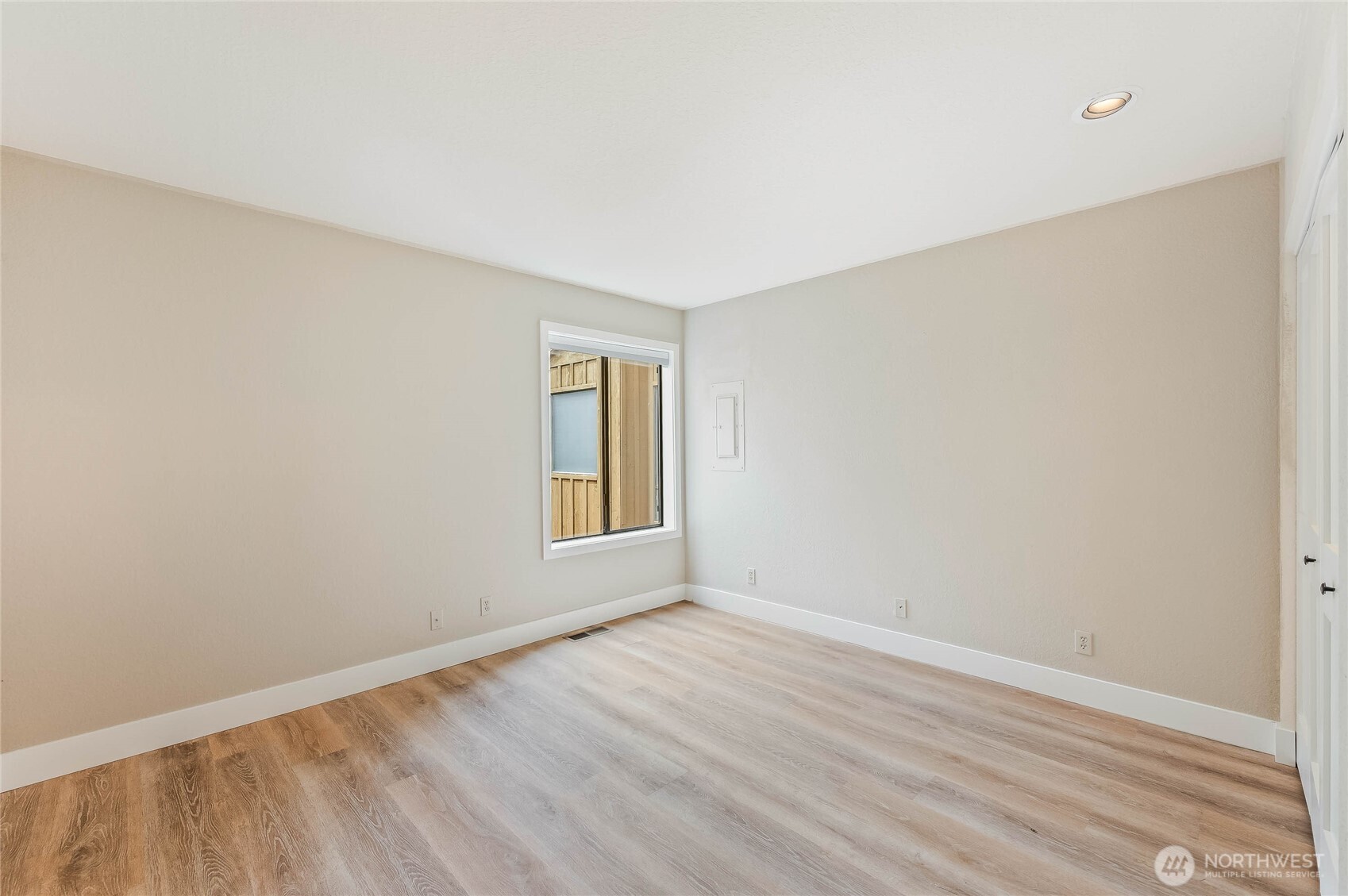 8975 Icicle Road, Unit F Leavenworth, WA 98826 - Photo 16 of 31 a view of an empty room with wooden floor and a window