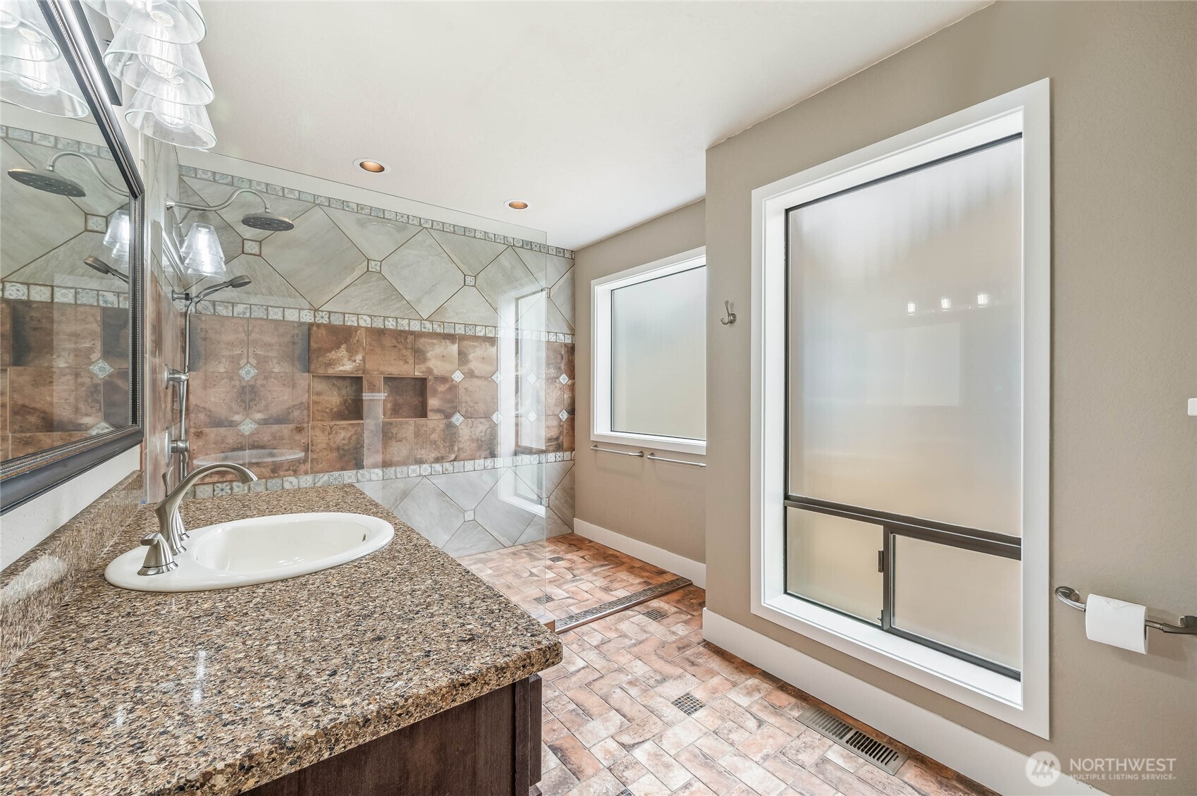 8975 Icicle Road, Unit F Leavenworth, WA 98826 - Photo 22 of 31 a bathroom with a granite countertop sink and mirror with bathtub