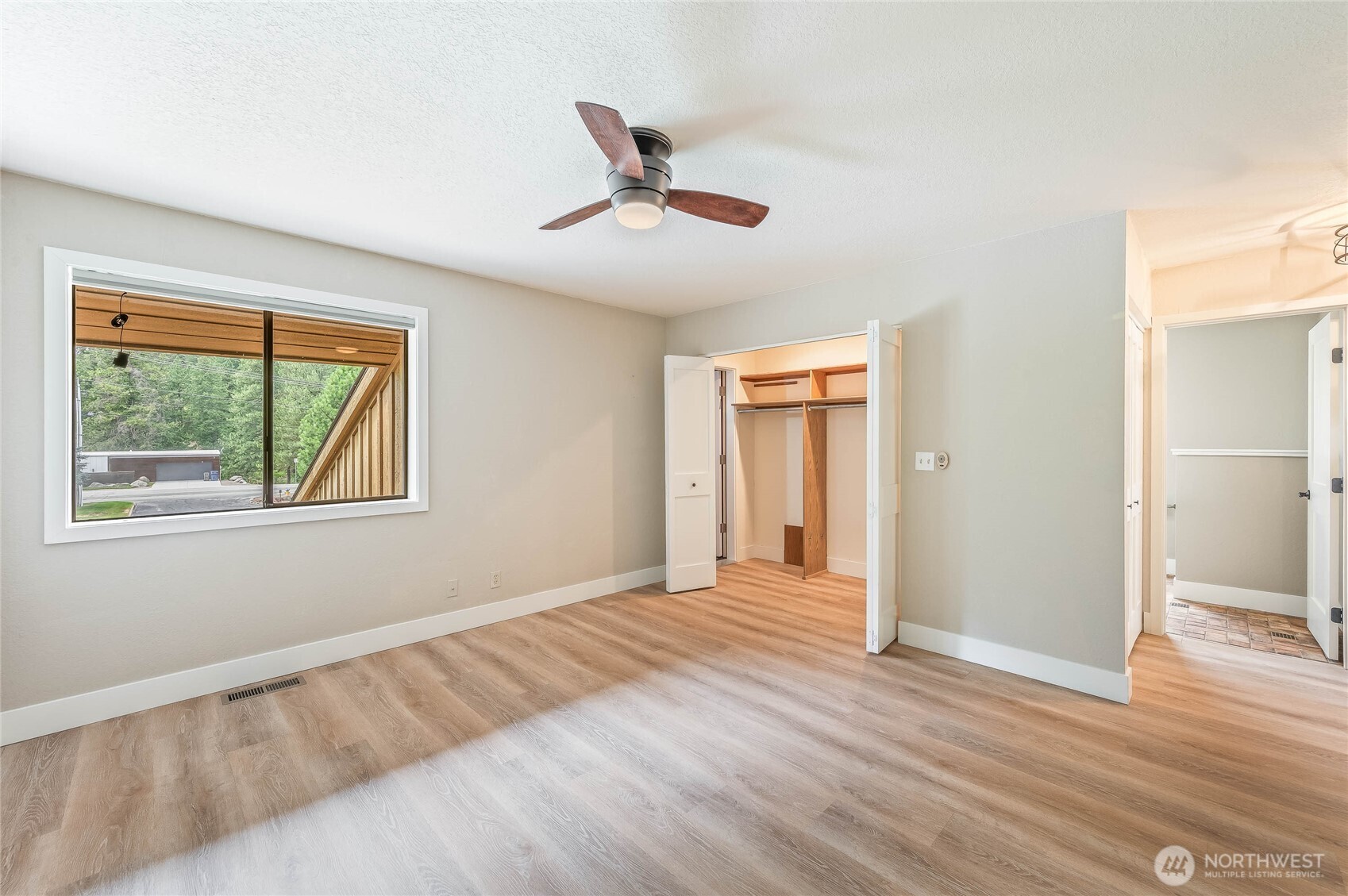 8975 Icicle Road, Unit F Leavenworth, WA 98826 - Photo 24 of 31 a view of an empty room with wooden floor and a window