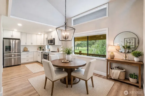 a view of a dining room with furniture a chandelier and wooden floor