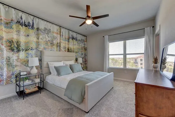 a kitchen with stainless steel appliances granite countertop wooden cabinets a sink a stove a microwave and wooden floors