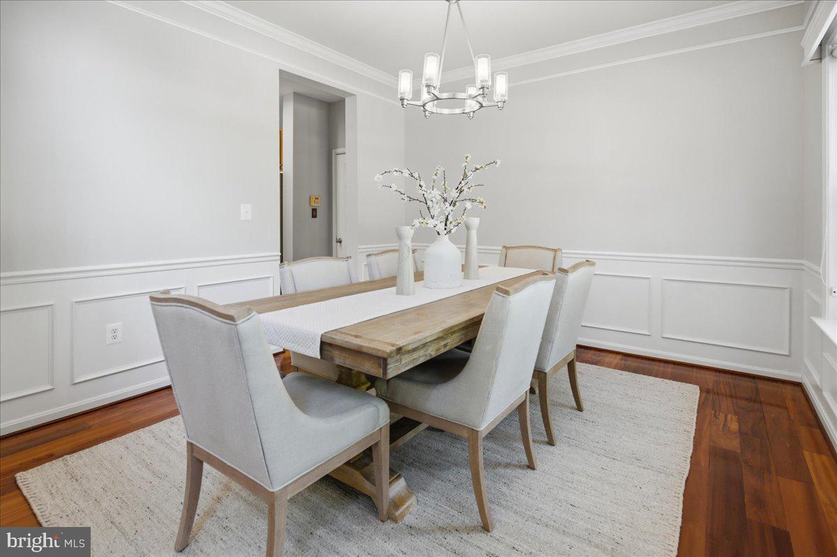 2424 Springbrook Court Huntingtown, MD 20639 - Photo 16 of 103 a dining room with furniture a chandelier and wooden floor