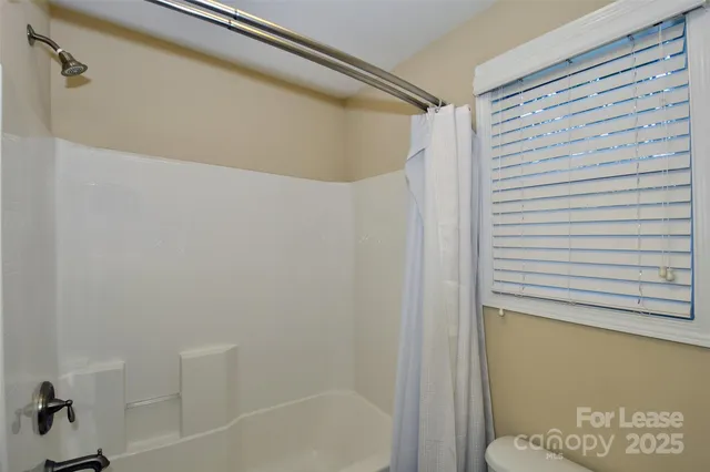a bathroom with a shower and a bath tub