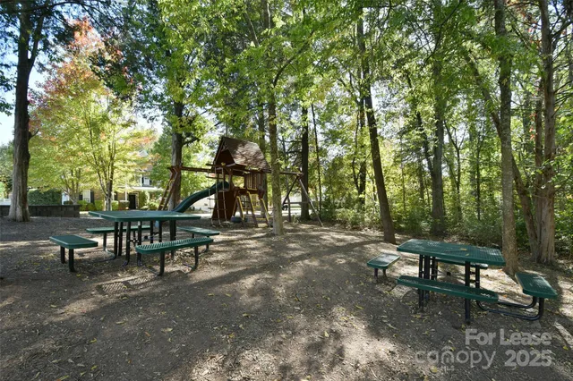 a backyard of a house with table and chairs