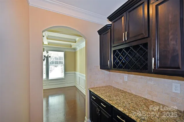 a kitchen with granite countertop cabinets washer and dryer
