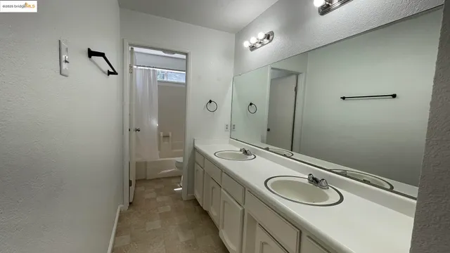 a bathroom with a sink double vanity and a mirror