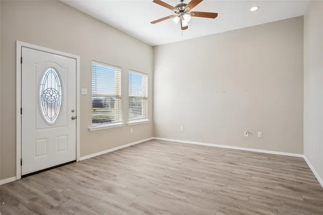 a view of a hallway with wooden floor