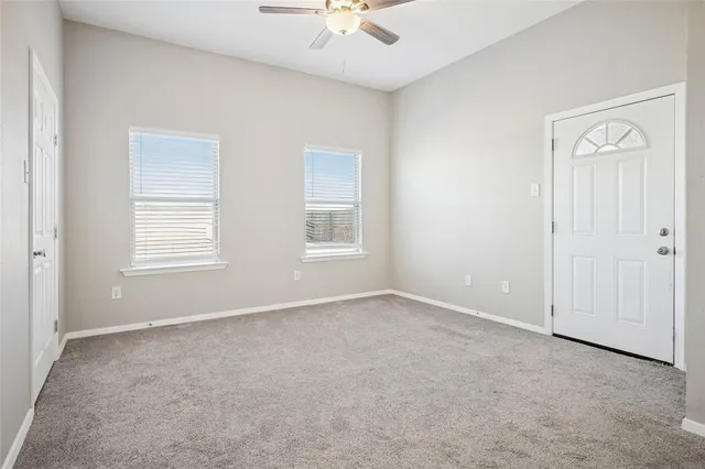 an empty room with closet and a bathroom