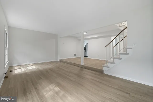 a view of entryway and hall with wooden floor