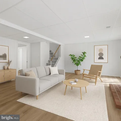 a living room with furniture and a potted plant