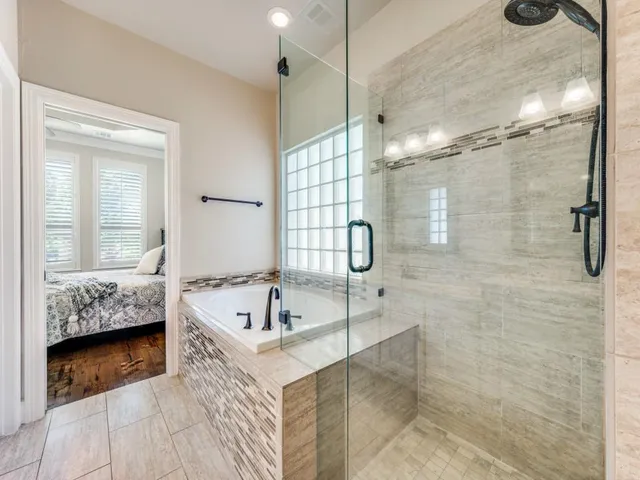 a bathroom with a tub a sink and a shower