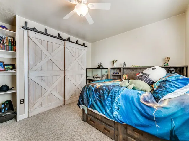 a bedroom with a bed and a white cabinets