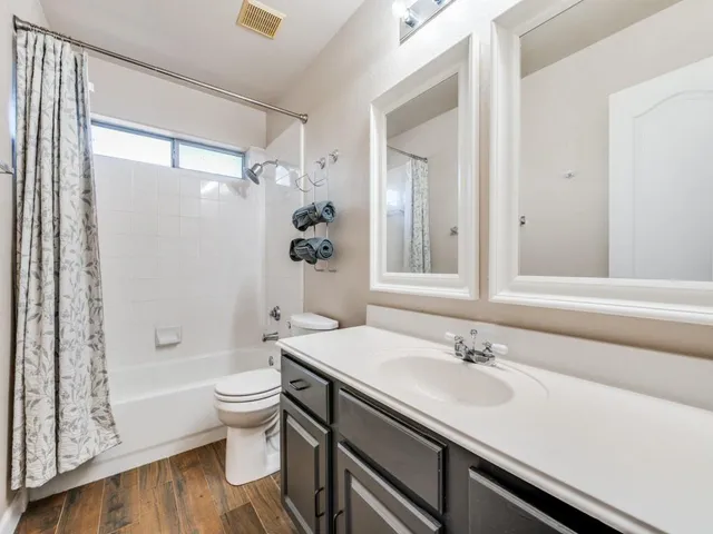 a bathroom with a sink toilet and shower