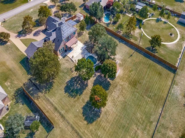 an aerial view of residential houses with outdoor space
