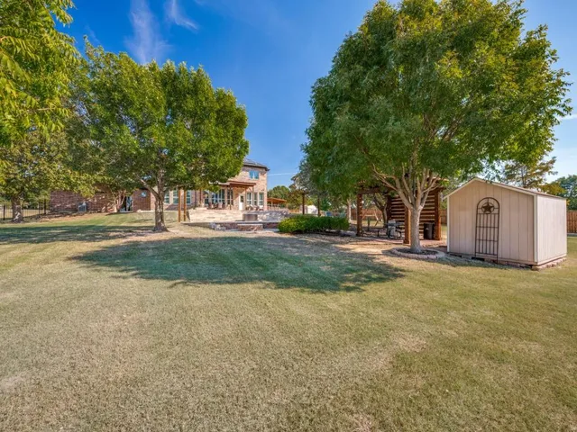 a view of a tree in front of a house