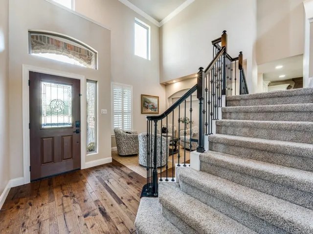 a view of entryway and hall with wooden floor