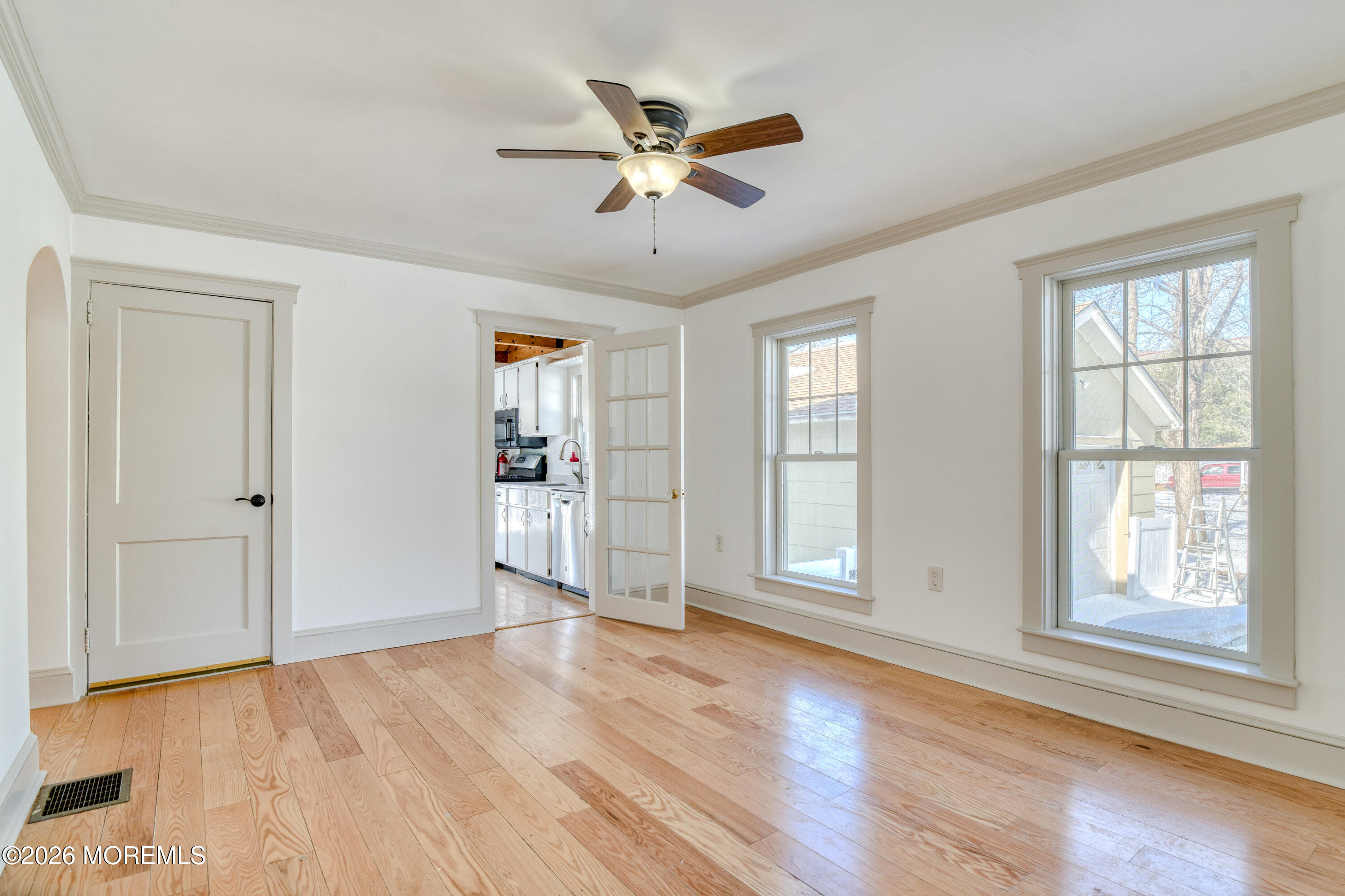 7 Schoolhouse Road Neptune Township, NJ 07753 - Photo 11 of 36 an empty room with wooden floor chandelier and windows
