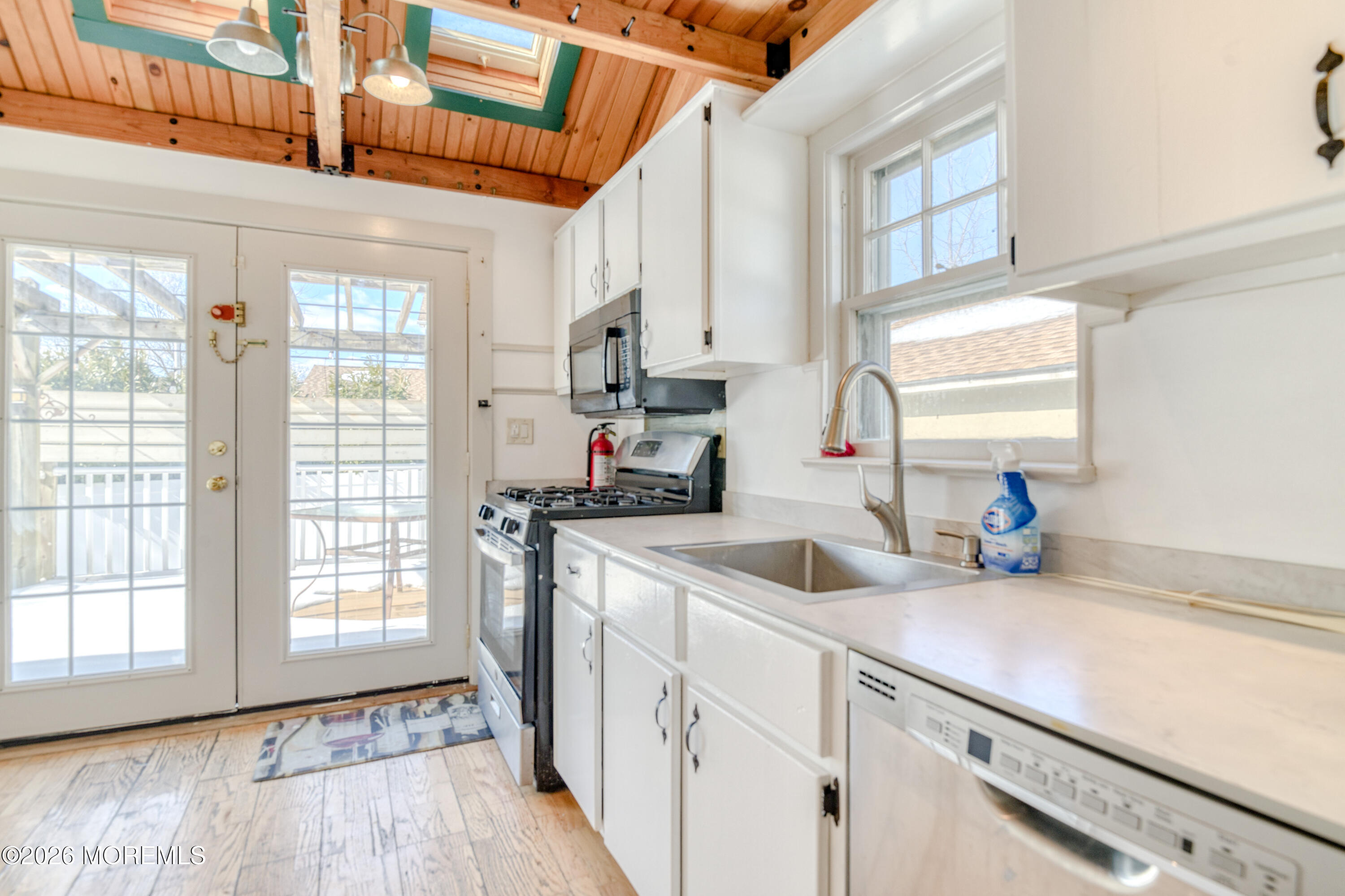 7 Schoolhouse Road Neptune Township, NJ 07753 - Photo 14 of 36 a kitchen with sink a window and stainless steel appliances