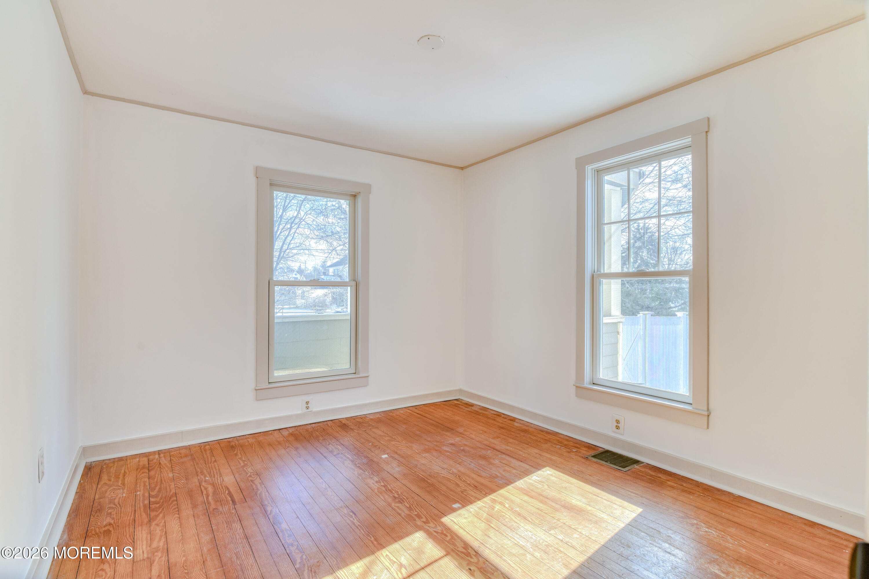 7 Schoolhouse Road Neptune Township, NJ 07753 - Photo 17 of 36 an empty room with wooden floor and windows