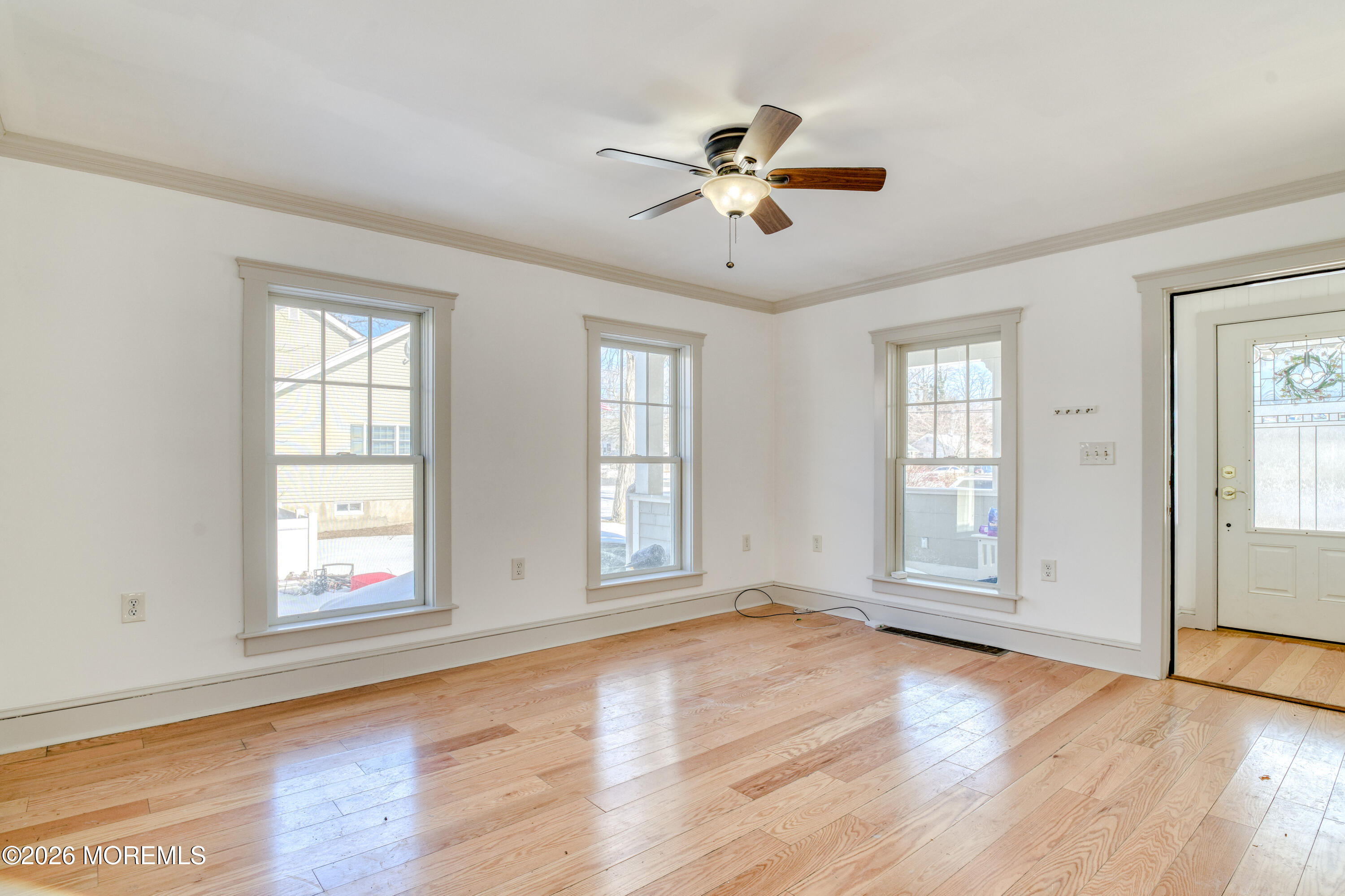 7 Schoolhouse Road Neptune Township, NJ 07753 - Photo 9 of 36 a view of an empty room with wooden floor and a window