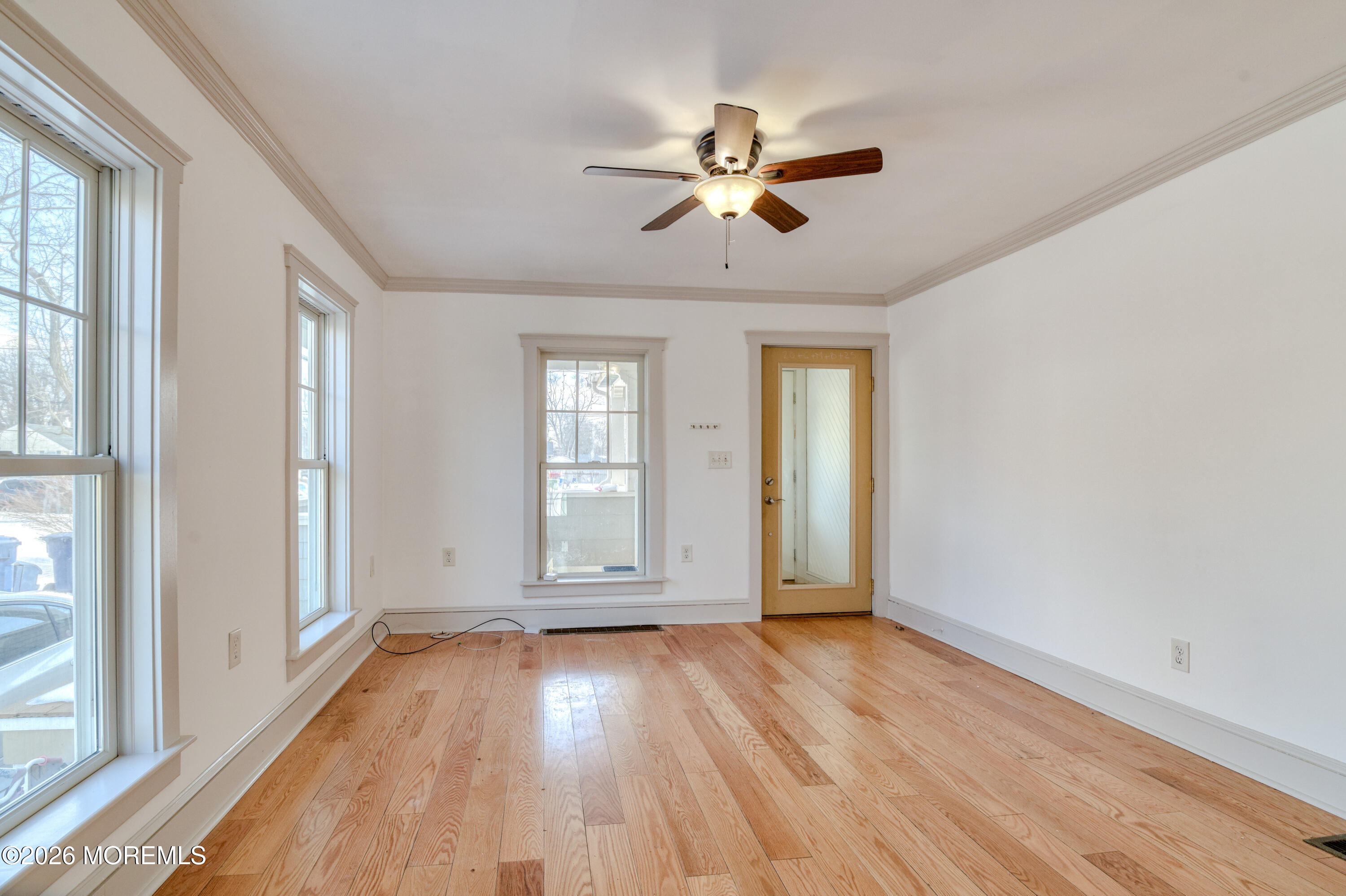 7 Schoolhouse Road Neptune Township, NJ 07753 - Photo 10 of 36 a view of empty room with wooden floor and fan