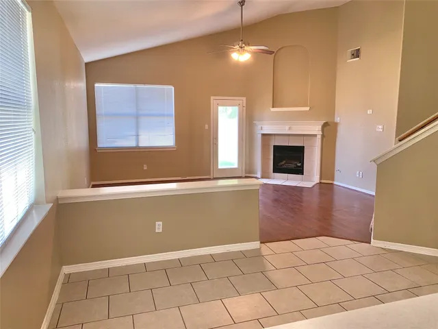 a view of livingroom with furniture fireplace and window