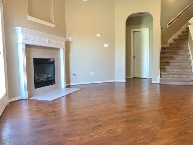 a view of an empty room with glass door and a window