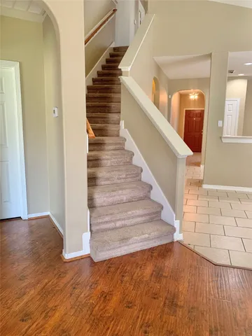 a view of entryway and hall with wooden floor