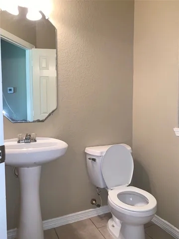 a white toilet sitting next to a bathroom sink