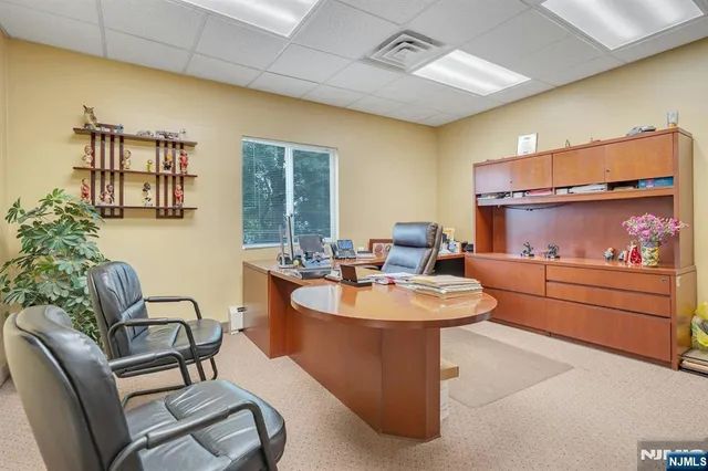 a view of a hallway with wooden floor and closet