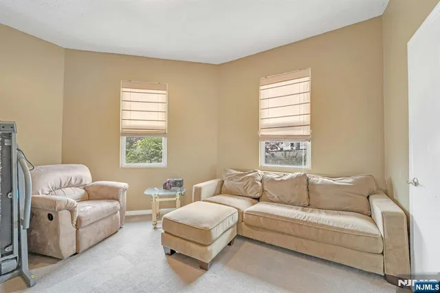 a kitchen with a sink a refrigerator and cabinets